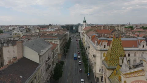 Forwards tracking of bus passing around long queue of cars in street. Old Stock Footage 249115850