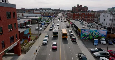 Forwards tracking of typical American yellow school bus stopping at traffic Stock Footage 183476047