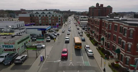 Forwards tracking of yellow school bus in streets of urban neighbourhood Stock Footage 183514109