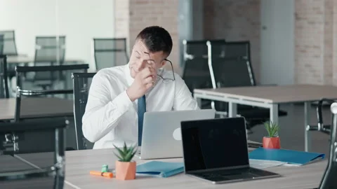 Forworn manager sitting at workspace Stock Footage 207479103