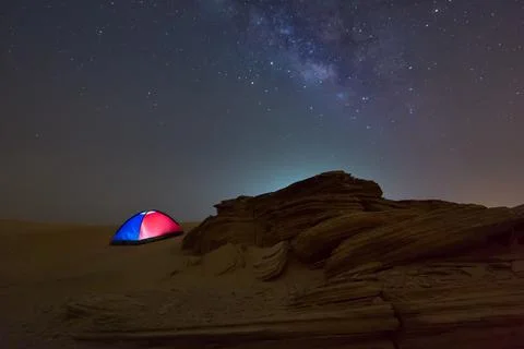 Fossil Rock dune in the desert of empty quarter at night milky way while camping Stock Photos