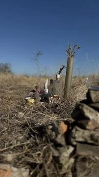Found-Object Still Life With Shell Casing Vase in a Dry Field Stock Photos
