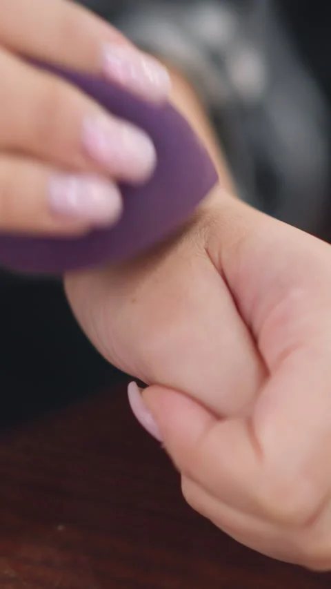 Foundation blending demonstration, Applying makeup with sponge technique Stock Footage 323619570