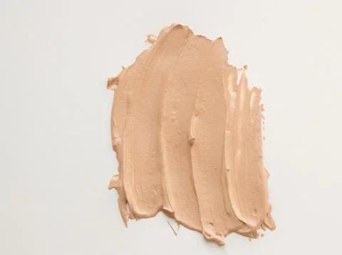 Foundation cream for makeup, make-up concept, smeared cosmetic cream on a whi Stock Photos