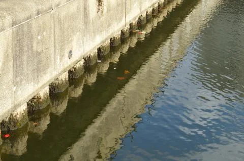 Foundation of the docks with reflection of the same in the Thames Stock Photos