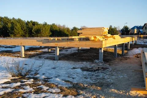 Foundation piles and base frame for wooden house, site preparation, startin.. Stockfoto's