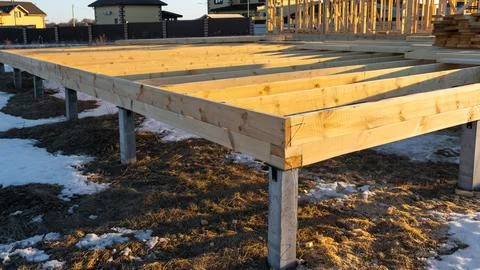 Foundation platform with timber beams, screw pile assembly for frame house,.. Stock Photos