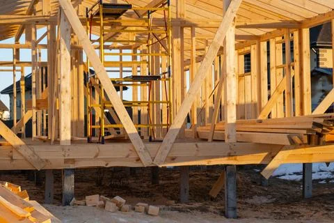 Foundation view of timber frame house, wooden beams, structure support, car.. 库存照片