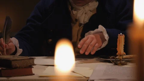 Founding Father with quill at tabletop, working by candleight - John Adams Stock Footage 105577205