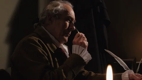 Founding Father at Tabletop, working with quill &amp; ink by candle light Stock Footage 105453823