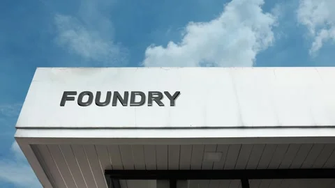 Foundry word sign displayed on building with blue sky background Stock Footage 318666558