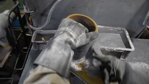 Foundry worker applying refractory paste coating inside pouring ladle with 動画素材 336681953
