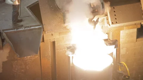 A Foundry worker looking at a full ladle Stock Footage 231496854