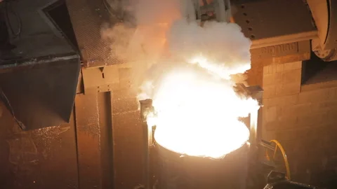 A Foundry worker looking at a full ladle Stock Footage 231496869