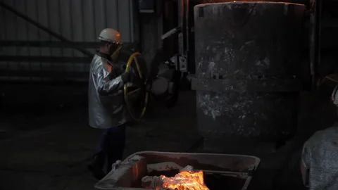 Foundry worker moving a ladle Stock Footage 231496713