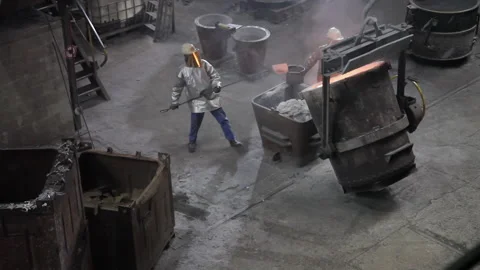 A Foundry worker taking melted metal out Stock Footage 231496832