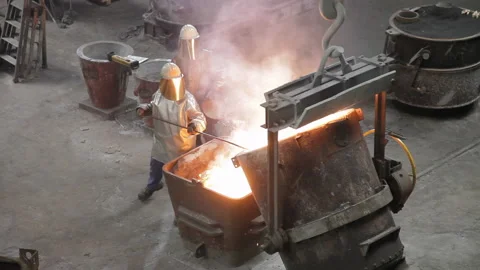 Foundry worker taking melted metal out Stock Footage 231496862