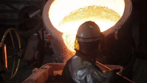 Foundry worker taking melted metal out Stock Footage 231496932