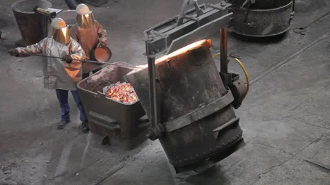 A Foundry worker taking melted metal out Stock Footage 231496986