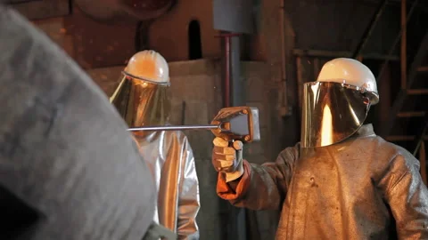 Foundry worker taking melted metal out Stock Footage 231497125