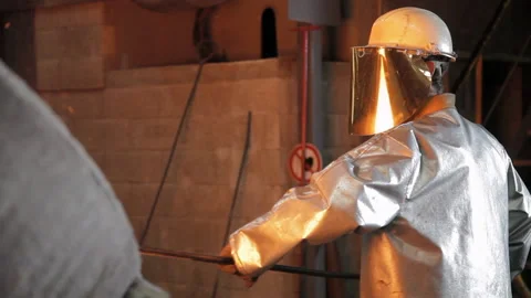 Foundry worker taking melted metal out Stock Footage 231497169