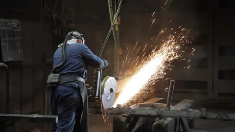 Foundry worker using a circular saw Stock Footage 231496786