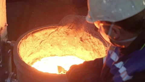 Foundry worker working with molten metal Stock Footage 197143358