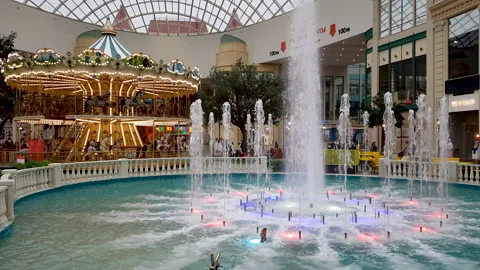Fountain against the background of the carousel Stock Footage 166077857
