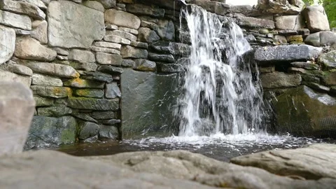 Fountain artificial waterfall in the park Stock Footage 159777899