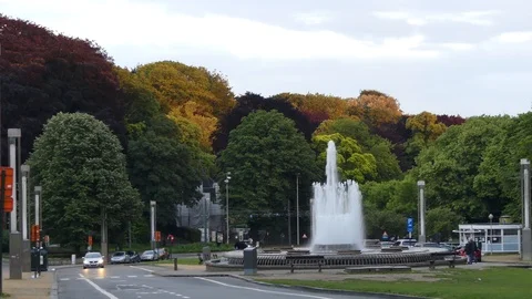 Fountain on the background of colorful trees in a park near the Atomium, an i Stock Footage 113932389