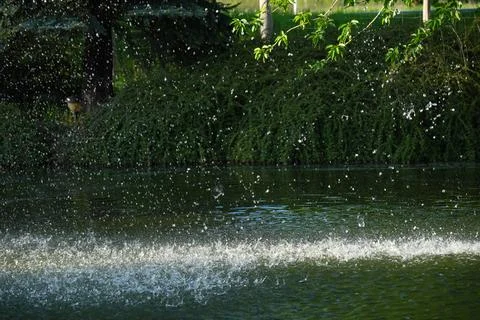A fountain creating a multitude of splashes of water against a backdrop of .. Stock Photos