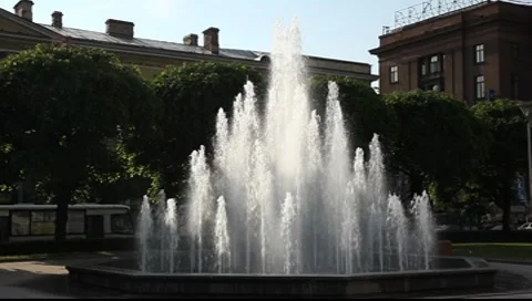 Fountain on the dark background backlit by sunlight, zooming Stock Footage 7133672