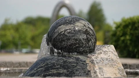 A fountain in the form of a ball on a summers day in slow motion. Stock Footage 247643714