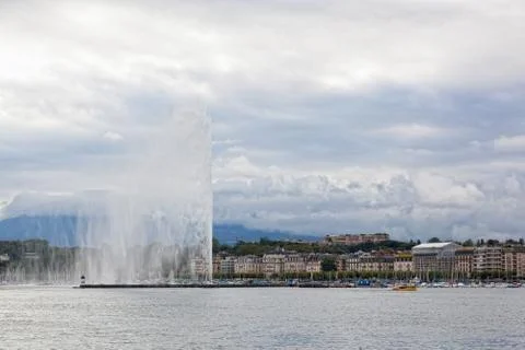 A fountain jet d eau rises over the water Fotos Stock