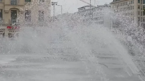 Fountain Jets Spraying in Front of City Buildings, Close Up Static Shot Stock Footage 343018146