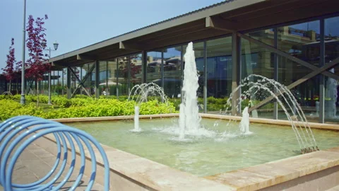 Fountain letting high jets of water attracts tourists Stock Footage 237004513