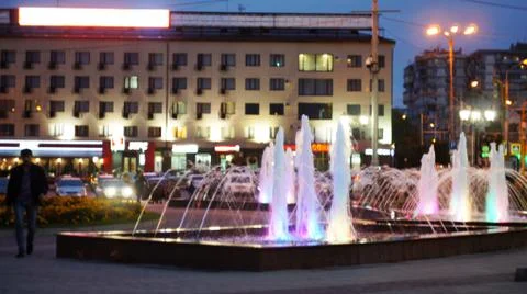 The fountain, lit by multicolored lights. Stock Photos