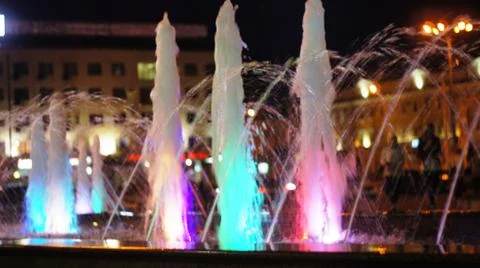 The fountain, lit by multicolored lights. Stock Photos
