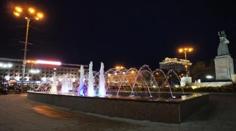 The fountain, lit by multicolored lights. Stock Photos