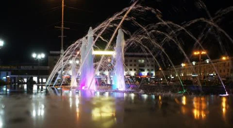 The fountain, lit by multicolored lights. Stock Photos
