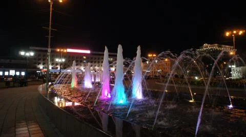 The fountain, lit by multicolored lights. Stock Photos
