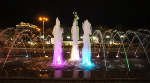 The fountain, lit by multicolored lights. Stock Photos