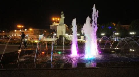 The fountain, lit by multicolored lights. Stock Photos