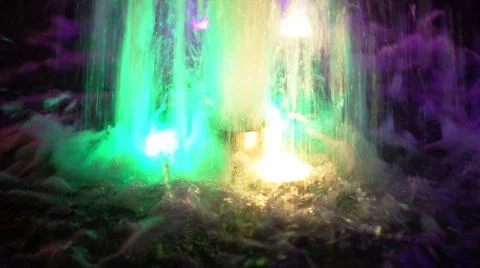 The fountain, lit by multicolored lights. Stock Photos