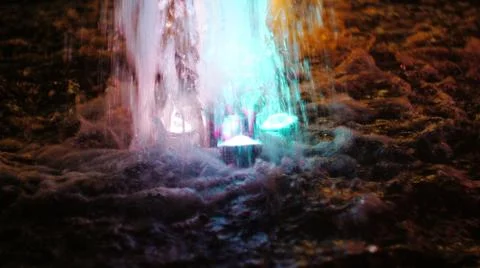 The fountain, lit by multicolored lights. Stock Photos