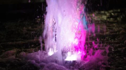 The fountain, lit by multicolored lights. Stock Photos
