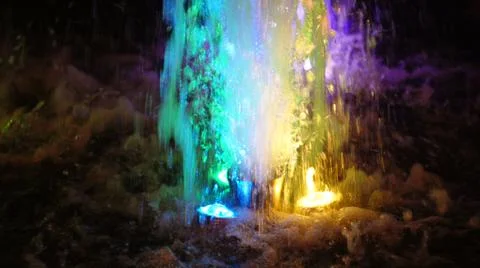 The fountain, lit by multicolored lights. Stock Photos