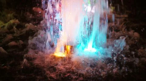 The fountain, lit by multicolored lights. Stock Photos
