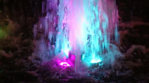 The fountain, lit by multicolored lights. Stock Photos