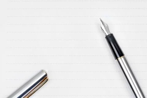 Fountain pen on a empty page of notepad Stock Photos